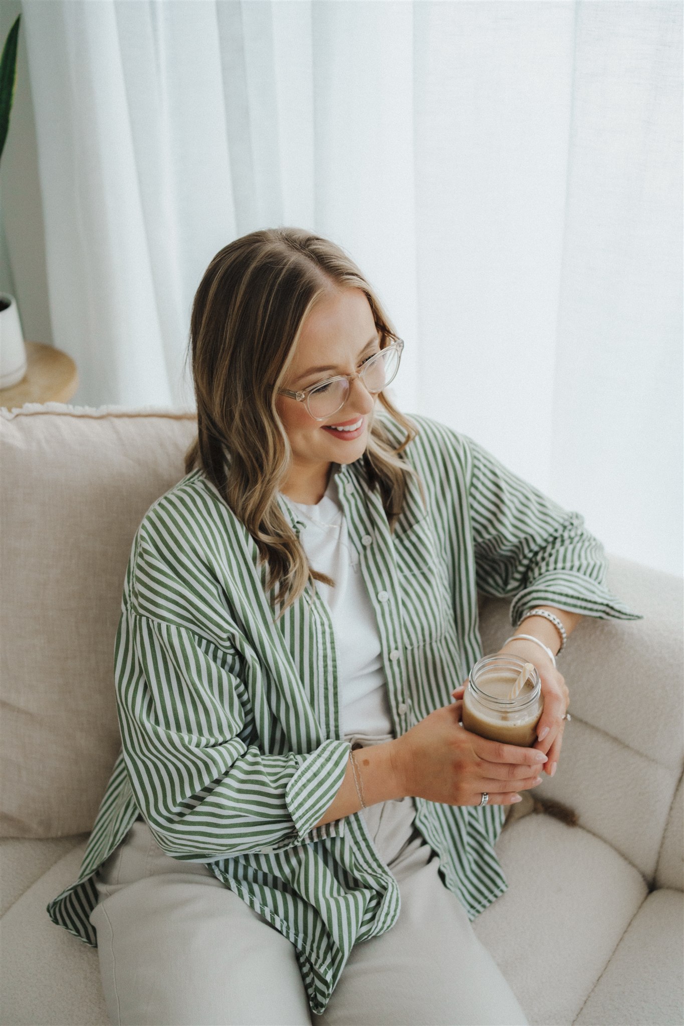women sitting smiling holding coffee